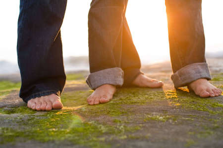a couple's feet on the beach