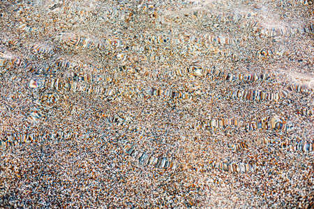 A background of beach sand through clear ocean water.の写真素材