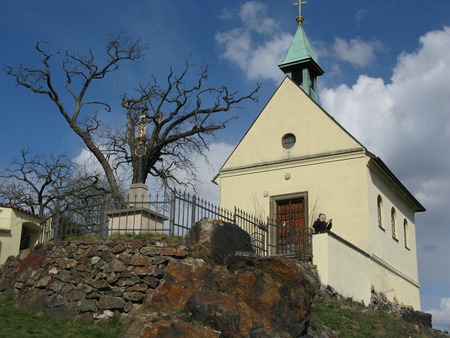The chapel - a historical relic of ancient times - on a small hill, a white wall in the background of blue skyの写真素材