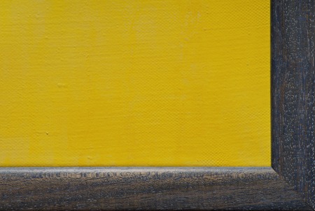 yellow canvas is in blue wooden frameの写真素材