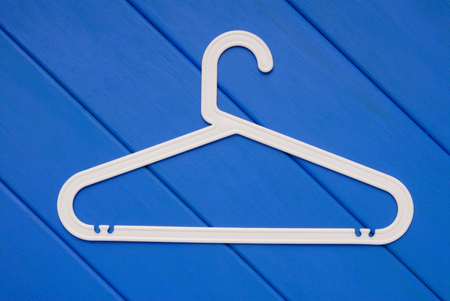 white plastic hanger in on blue wooden floorの写真素材