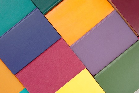 pile of multicoloured books, bunch of multicolored books, heap of books, backgrounds is out of multi-colored books, textured backgroundの写真素材