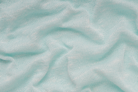 light blue  background stockinette; draped jersey; wrinkled tricot; knitted fabric; turquoise...