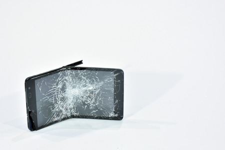 Cell phone with the screen broken by a hammerの写真素材