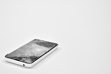 Cell phone with the screen broken by a hammerの写真素材
