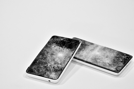 Cell phone with the screen broken by a hammerの写真素材