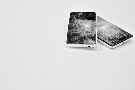 Cell phone with the screen broken by a hammerの写真素材