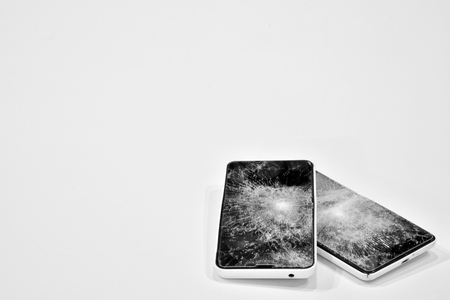 Cell phone with the screen broken by a hammerの写真素材