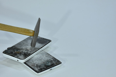 Cell phone with the screen broken by a hammerの写真素材