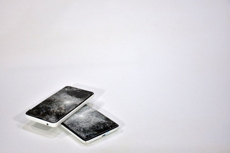 Cell phone with the screen broken by a hammerの写真素材
