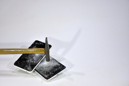 Cell phone with the screen broken by a hammerの写真素材