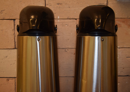 Thermos bottle for beverages. Two thermal coffee bottles to serve in event with many people.の写真素材
