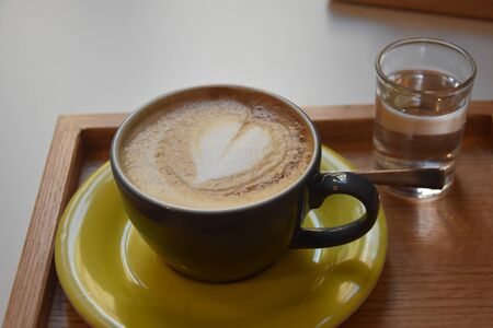 A lovely and romantic cup of coffee. Artwork made in coffee cream. Selective focus.の写真素材