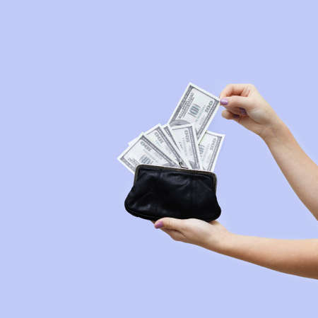 isolated female hands holding black leather wallet removing money from it
