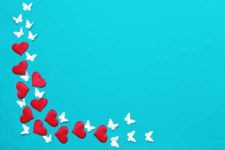 Colorful valentine background, greeting card made of red textile hearts and hand made white...