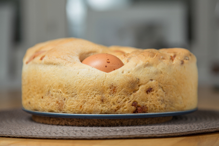 Neapolitan salty cake known as Tortano or Casatiello, homemade food. It contains eggs, salami, bacon, butter, salt and pepper. Baked.の写真素材