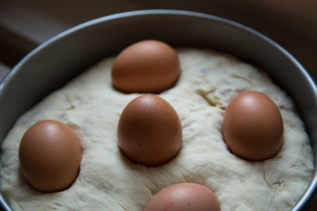 Neapolitan salty cake known as Tortano or Casatiello, homemade food. It contains eggs, salami, bacon, butter, salt and pepper. Raw, before baking.の写真素材