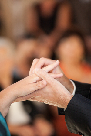 Hands detail with wedding rings exchange, during a weddingの写真素材