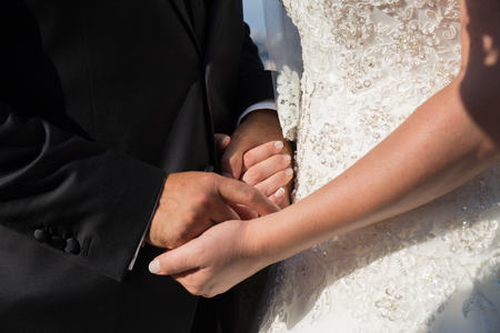 Hands detail with wedding rings exchange, during a weddingの写真素材
