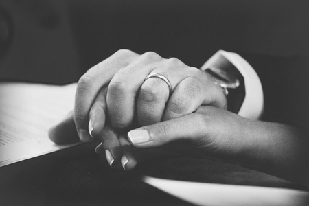 Hands detail with wedding rings exchange, during a weddingの写真素材