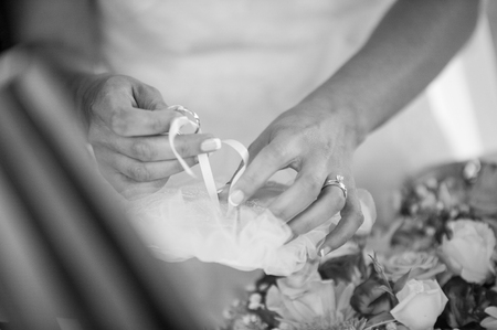 Hands detail with wedding rings exchange, during a weddingの写真素材
