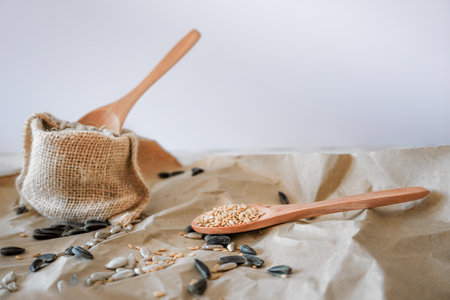 bag with sunflower seeds and wooden spoon brown background with white copy spaceの写真素材