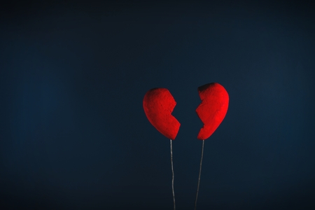 Conceptual of broken heart on the dark blue background.の写真素材