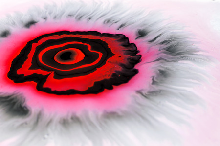 Abstract artwork on the water.From black and red color.
