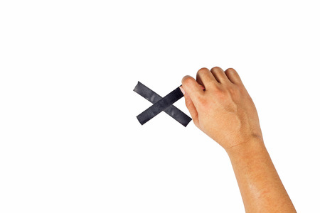 The concept of hands is about to taped to a black cross.