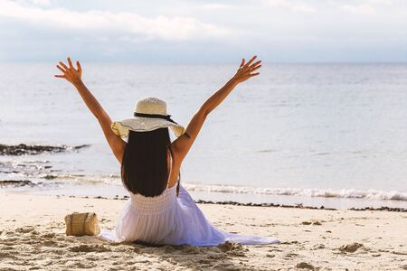 The girl sat with her back in a happy posture.の写真素材
