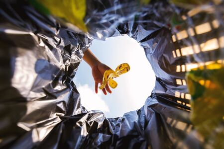 Banana peel was thrown into the garbage bag for disposal. Look from the inside of the basket.の写真素材