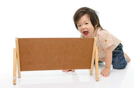 Cute baby with a woodboardの写真素材
