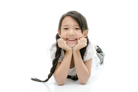 Little cute asian girl resting chin by hand on white
