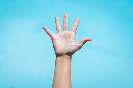 hand with the sky as backgroundの写真素材
