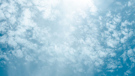 Blue sky with sun and cloudの写真素材