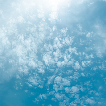 Blue sky with sun and cloudの写真素材