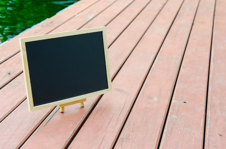 Black board on wood floor for copy spaceの写真素材