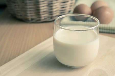 Close up glass of milk onwooden table with copy space,Vintage filterの写真素材