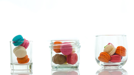 Colorful macaroons in glass isolated on white background with copy spaceの写真素材