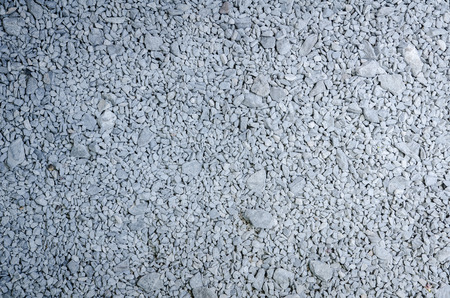 background made of a closeup of a pile of pebblesの写真素材