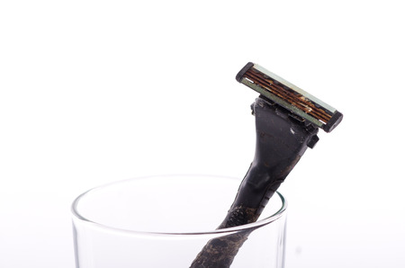 Close up dirty shaving razor on white background isolatedの写真素材