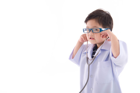 Cute asian child in a doctors uniform on white background isolated with copy spaceの写真素材