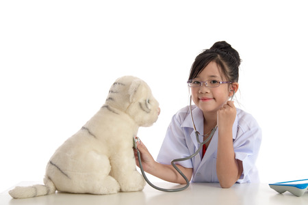 Little asian girl playing a doctor isolated on white backgroundの写真素材