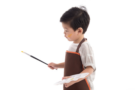Cute little asian boy painting isolated on white backgroundの写真素材