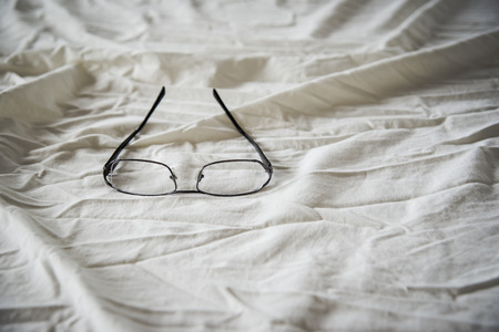 Modern Glasses on white bed in the morning sunday for backgroundの写真素材