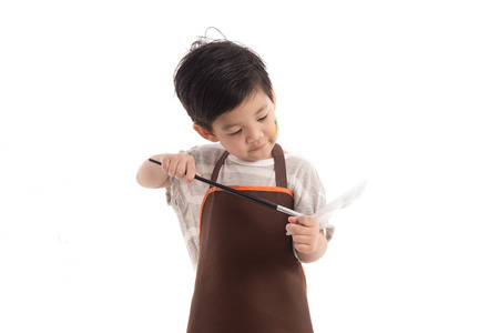 Cute little asian boy painting isolated on white backgroundの写真素材