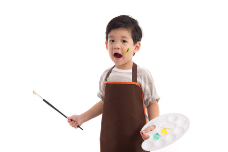 Cute little asian boy painting isolated on white backgroundの写真素材