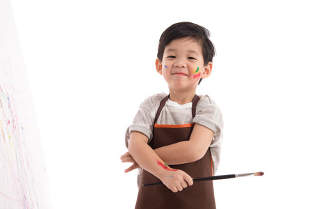 Cute little asian boy painting isolated on white backgroundの写真素材
