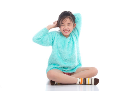 Beautiful asian girl sitting on white background isolatedの写真素材