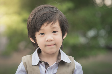 Happy  asian boy smiling and looking at camera portrait,vintage filterの写真素材